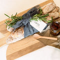 Bread and jam set on a wooden board with a gift tag, on a light background