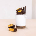 White container with chocolate bars on a beige background