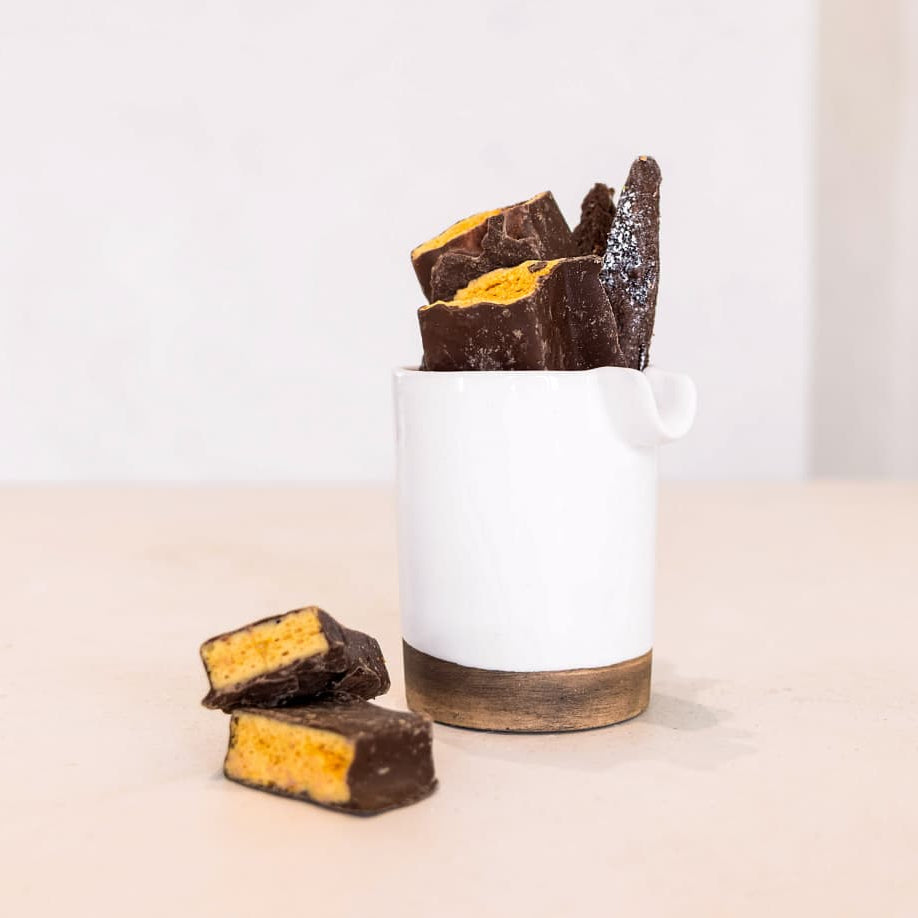 White container with chocolate bars on a beige background