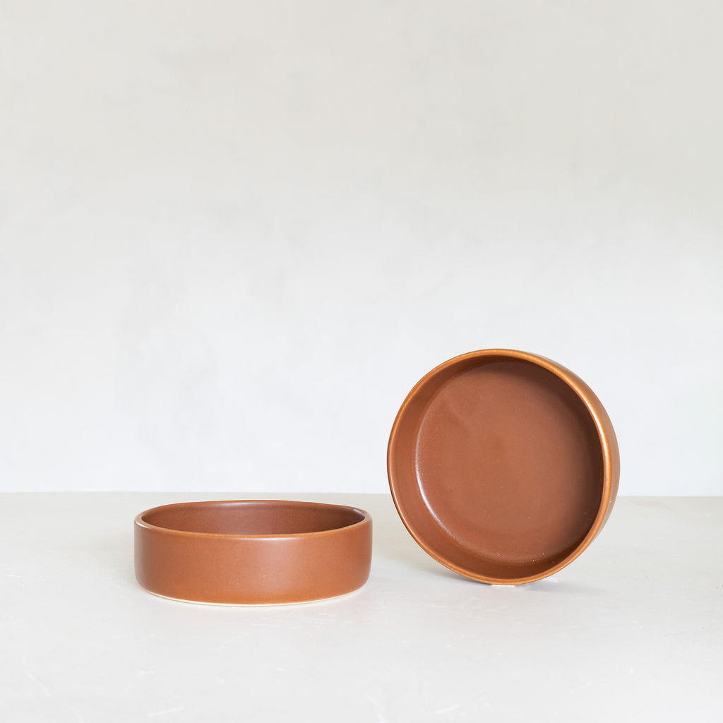 Two terracotta bowls on a white background