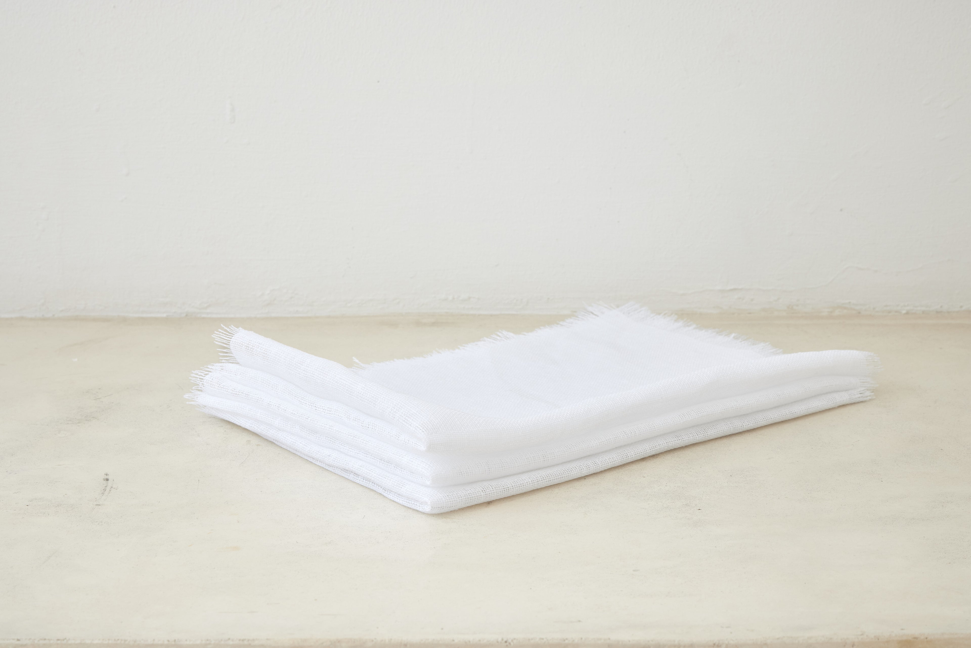 Trend{ING}s Linen Challah/Bread Cover in white; folded on top of each other