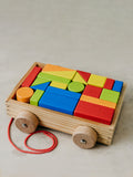 Trend{ING} Baby's building blocks on wheels colurful geometric game in a pull trolley