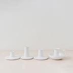Trend{ING}s White gloss ceramic candle holders standing together on a table with 3 different sizes 