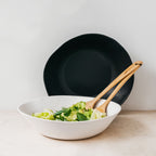 Trend-ings Acacia deep stone serving bowl in speckled white and coal colours, with a salad and salad servers in the bowl