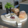 Trend-ings thick round wooden serving board with handle (45cm), with breads, olives, hummus dip and plant on the board